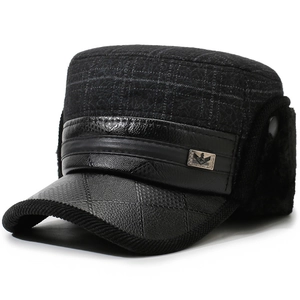 Detail of winter flat top cap with ear protection and textured leather brim for elderly men