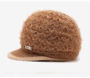 Close-up of brown knit hat featuring plush fur texture and rhinestone LOVE metal letters