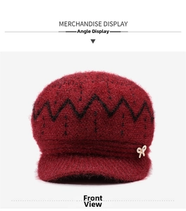 Detail of burgundy knit hat with fleece lining, pearl bow brooch and wavy texture