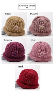 Detail view of knitted hats with plush 3D flower and pearl decor in five colors