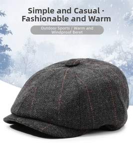 Detail of dark grey herringbone beret cap featuring subtle red plaid texture and wool fabric