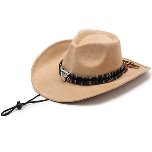 Detail of camel suede cowboy hat with ethnic braided band and silver bull skull ornament