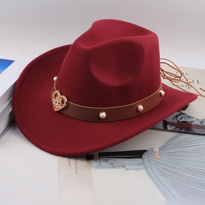 Detail of burgundy wool fedora featuring pearl leather band and gold heart buckle charm