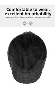 Detail of dark grey herringbone flat cap with breathable black mesh lining and red stitching