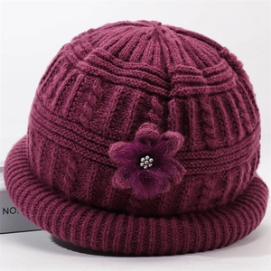 Purple winter knitted hat for elderly women with decorative floral accent and warm lining