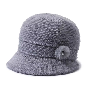 Close-up of grey knit hat for elderly women showing flower detail and soft texture