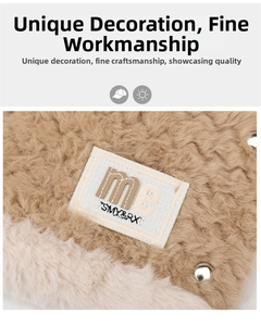 Close-up of plush bear hat fabric with stitched logo patch and metal rivet detail