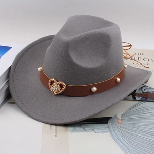 Detail of grey felt fedora with brown leather band, pearl studs and gold heart buckle