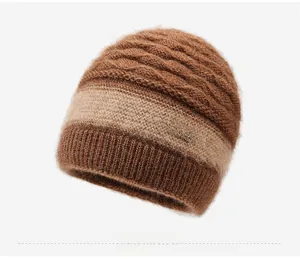 Detail view of winter knit hat with cable texture and metal LOVE charm embellishment