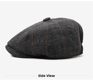 Side view of dark gray herringbone newsboy cap with red plaid pattern and top button