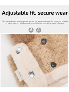 Detail of plush beige winter hat featuring adjustable metal buckle and soft faux fur texture
