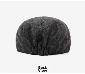Detail of grey herringbone beret with red windowpane check and elastic back closure