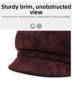Detail of stiff brim on dark red beret cap with vintage pattern fabric texture