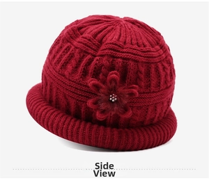 Detail of dark red knit hat featuring a 3D floral accent and warm fleece lining