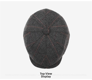 Top view of grey herringbone newsboy cap with orange stripes and center top button detail