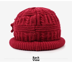 Detail view showing back of wine red cable-knit winter beanie with ear protection