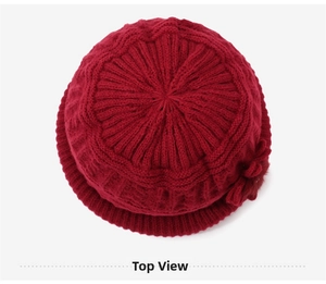 Top view of deep red knitted hat showing detailed textured pattern and warm fabric