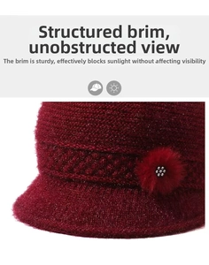 Detail of red knit hat with brim, glittering thread, and rhinestone fur flower