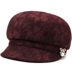 Deep burgundy newsboy cap featuring floral texture and a pearl bow brooch detail