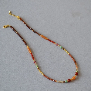 Detail of double-layer beaded necklace with garnet, agate and turquoise gemstones