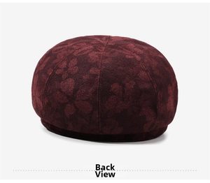 Detailed back view of a dark red newsboy cap featuring elegant floral jacquard texture