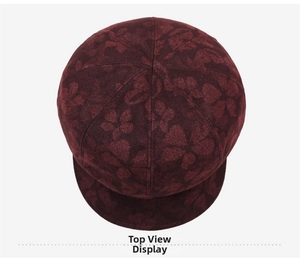 Top view detail of dark red floral pattern textured newsboy beret with eight-panel design
