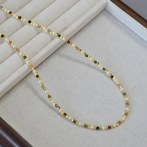 Close-up of elegant beaded necklace with colorful tourmaline stones and white pearls