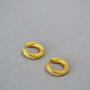 Minimalist gold twisted rope hoop earrings with a textured metallic glossy finish