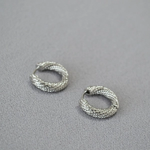 Polished silver twisted hoop earrings with elegant braided texture in a 45-degree view