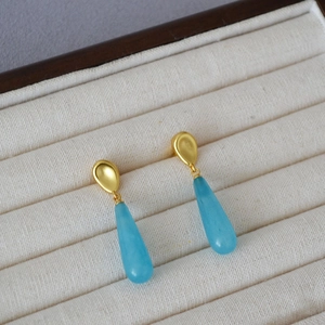 Minimalist brass earrings with gold plating and light blue teardrop stone pendants