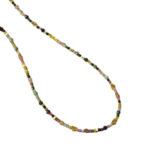Colorful tourmaline beaded necklace with gold heart charms on white background