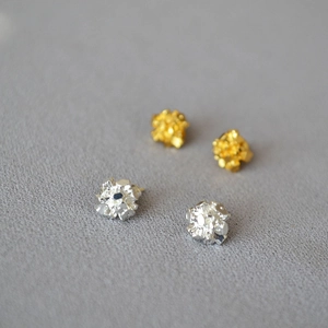 Detailed view of textured gold and silver irregular crystal cluster stud earrings