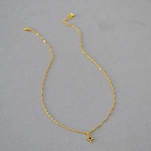 Double-layered gold star necklace with compass pendant and adjustable clasp