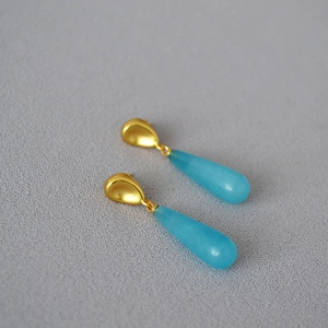 Vintage gold plated brass drop earrings featuring translucent blue waterdrop gemstones