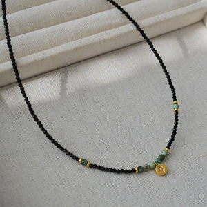 French retro beaded necklace with black spinel, turquoise, and a gold star pendant