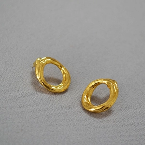 Textured gold-plated irregular oval hoop earrings with a minimalist hammered finish style