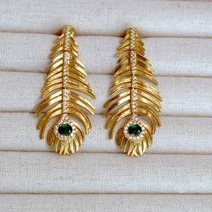 Vintage golden peacock feather earrings with green emerald stones and white zircon accents