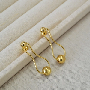 Elegant gold drop earrings with a brushed spherical pendant and polished pear-shaped frame