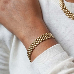 Golden multi-row mesh chain bracelet in brass with premium metallic texture and clasp