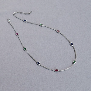 Detail of brass necklace with multicolored rectangular gemstones and adjustable lobster clasp