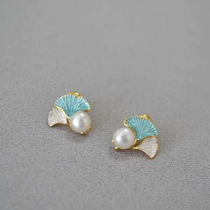 Macro detail of ginkgo leaf earrings with fresh water pearls and colorful enamel inlay