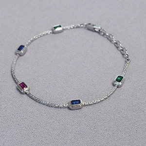 Elegant gold-plated brass chain necklace featuring rectangular red, blue, and green gems