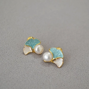 Detail of ginkgo leaf stud earrings with blue enamel and freshwater pearl inlay