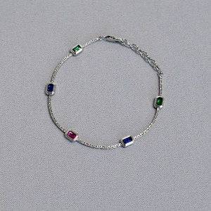 Detailed view of the silver chain necklace with five colorful rectangular cut zircon gemstones