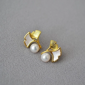 Elegant gold ginkgo leaf earrings featuring freshwater pearls and brushed textures