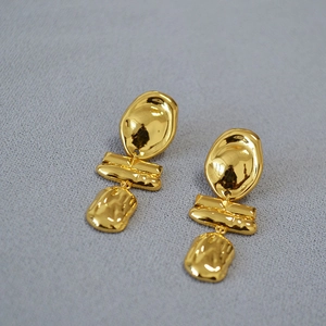 Irregular gold-plated brass drop earrings with hammered lava texture in modern style