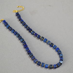 Detail of lapis lazuli square beads necklace with gold metal spacers and lobster clasp