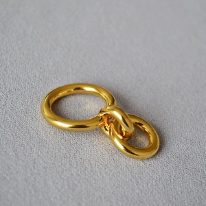 Minimalist double interlocking golden brass rings with a high polished mirror finish