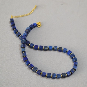 Detail of square lapis lazuli beads and gold spacer beads on vintage cube necklace