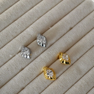 Irregular lava design earrings in gold and silver finish with marquise cut zircon stones